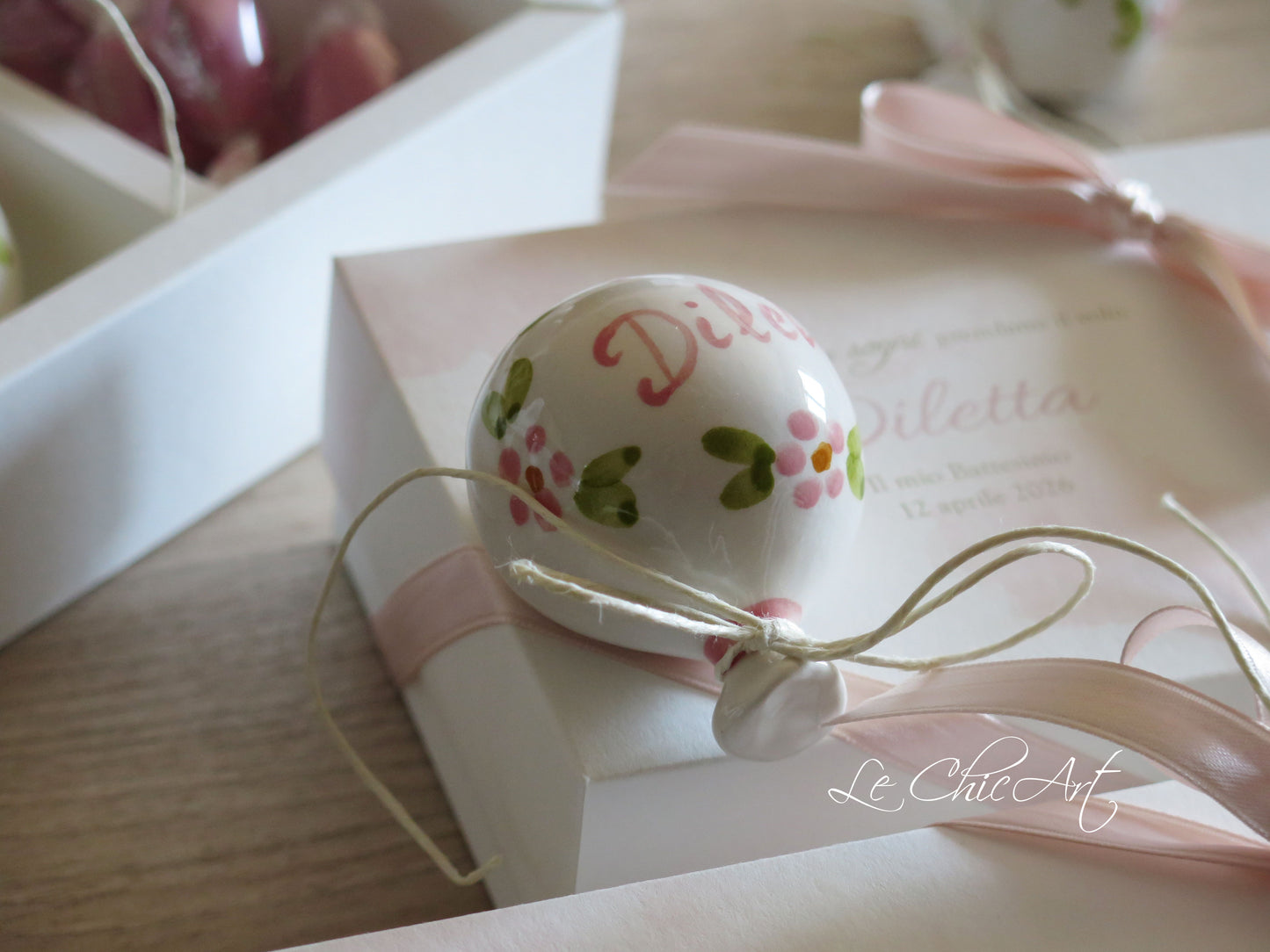 Small, rounded christening balloon favor set with name