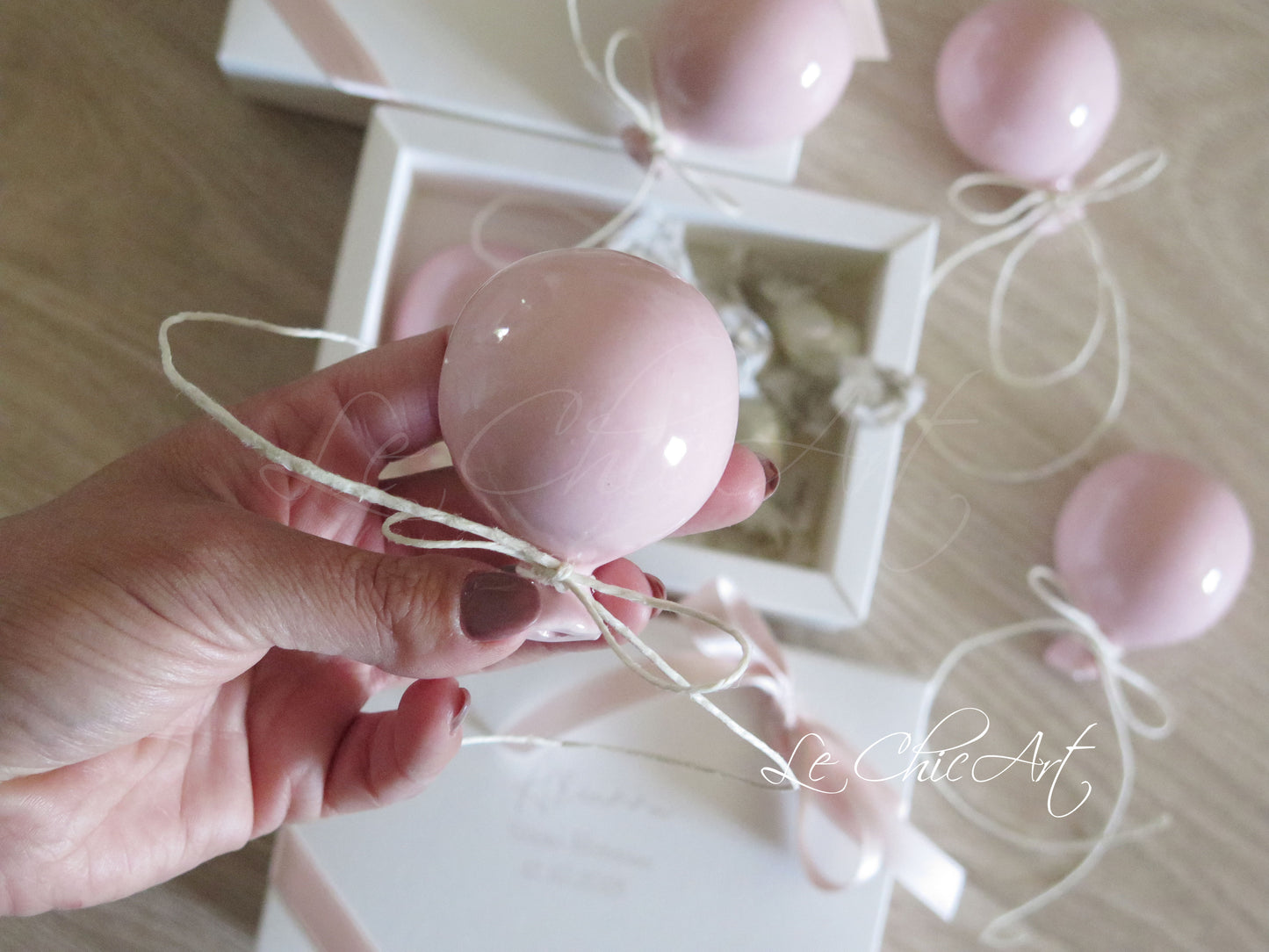 Small, rounded christening balloon favor set with name